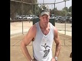 Coach shows two female athletes how to properly handle a big bat