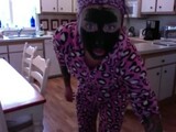 Felicity Feline dancing and being a weirdo in a onesie and green face mask