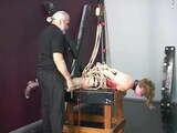 Lovely young slave girl in lingerie is restrained in the sex basement by master