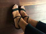 Beautiful strappy sandals in black on beautiful feet.